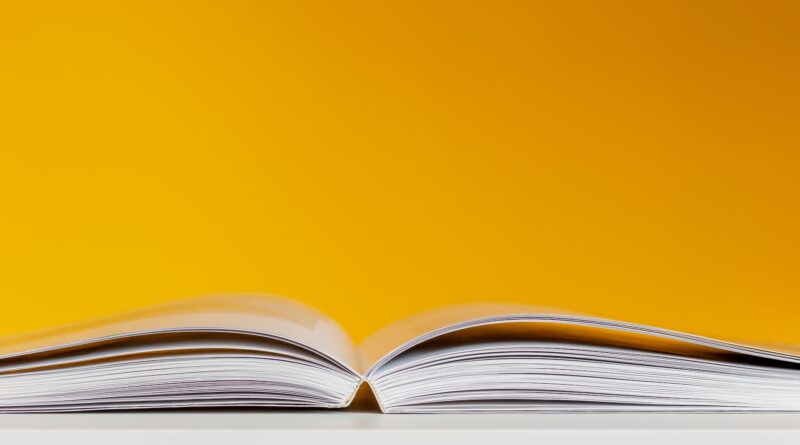 white book in white table near yellow wall